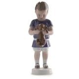 Boy holding a dog in front of him, Ole. Bing & Grondahl figurine no. 1747