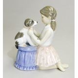 Girl trying bow tie on dog, Royal Copenhagen figurine