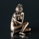 Siddende dame med armene om sig selv, bronzefinish