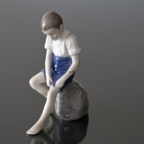 Boy sitting on stone rolling up trousers, Bing & Grondahl figurine No. 1757