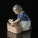 Mädchen liegt sanft die Puppe in den Korb, Bing & Gröndahl Figur Nr. 2307