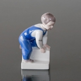 Boy crawling up the stairs of life, Bing & Grondahl figurine no. 2399