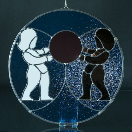 Glass relief with brown and white people, blue background