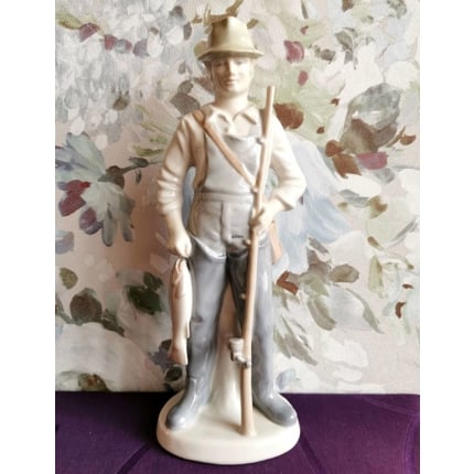 Figure of fisherman with fish and fishing rod, marked GDR 22