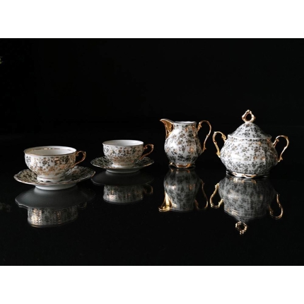 Espressotassen mit Untertassen mit Zuckerdose und Sahnekännchen