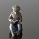 Boy, sitting reading, figurine Dahl Jensen