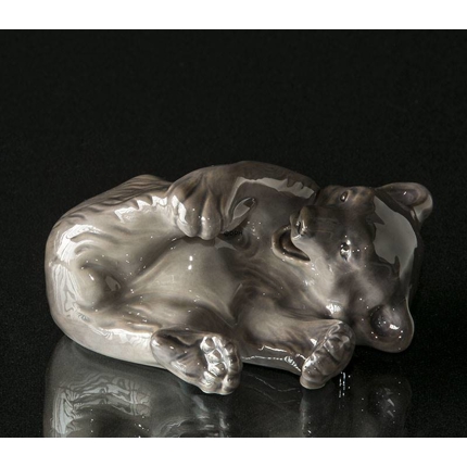 Brown bear playing with its foot, Royal Copenhagen figurine no. 1233-729