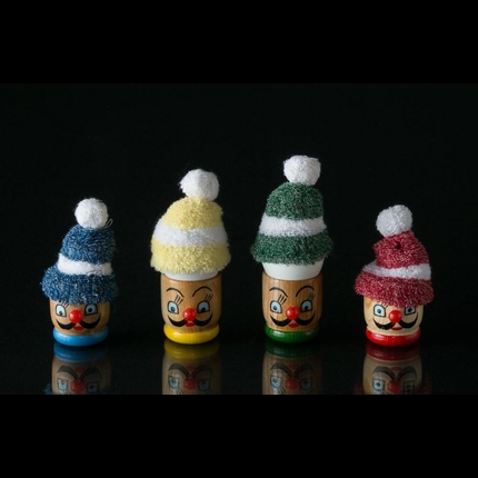 Egg cup with face and small hat for the egg in red, blue, yellow and green