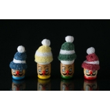 Egg cup with face and small hat for the egg in red, blue, yellow and green
